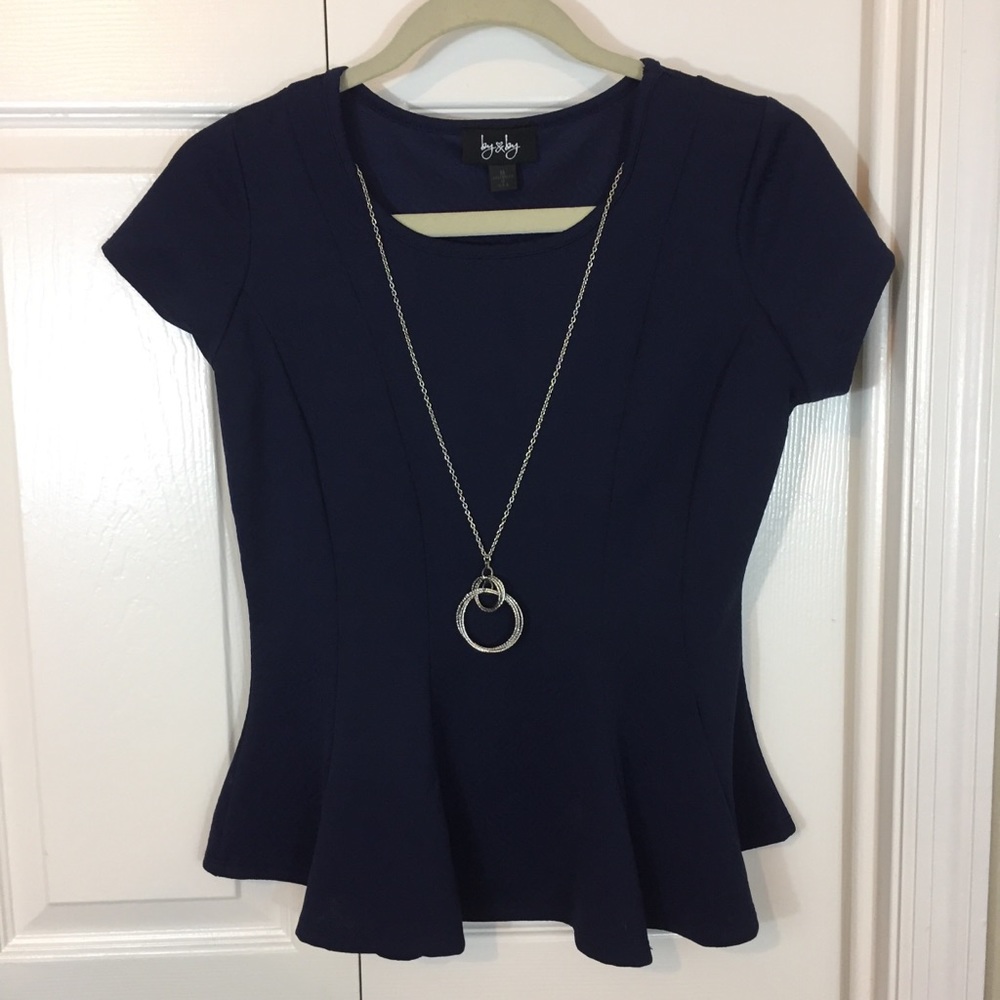 Navy blue peplum top with fashion necklace.